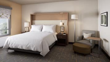 A hotel room with a bed, bedside tables, a chair, a small table, and a lamp.