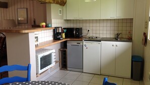 A compact kitchen with white cabinets, a microwave, a coffee maker, and a sink. - very quiet rural house (hodeng-hodenger)
