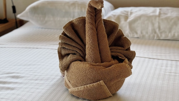 A bed with a towel sculpture in the center. - 3B| Wellness Hotel & Hostel (Playa del Carmen)