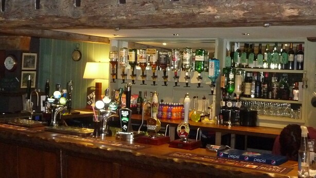 A bar with a wooden sign reading "THE CROWN". - The Crown - Hutton le Hole (York)