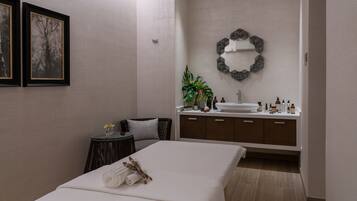 Relax in a serene space with a neatly made bed, comfortable chair, and vanity.