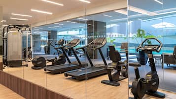 A modern gym with treadmills, elliptical machines, and weight machines.