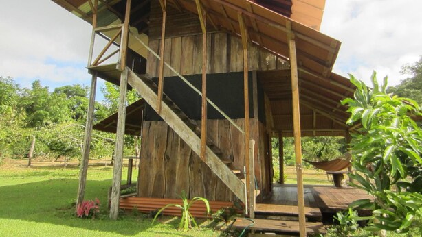 A rustic wooden structure with a staircase leading to an upper level. - EcoFarm Casa Pequeña (Drake Bay)