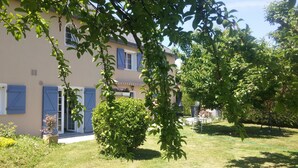 A two-story building with a garden in front.