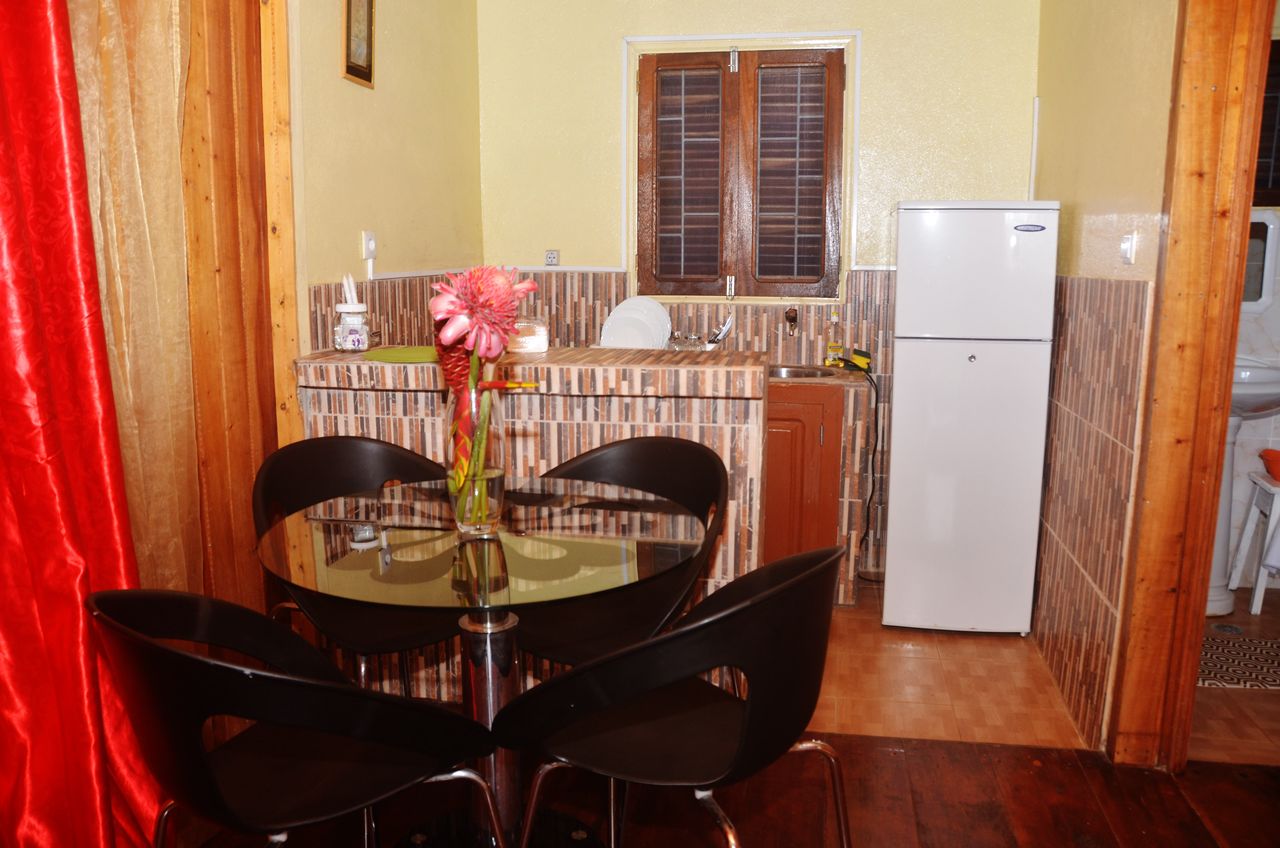 A compact kitchen with a dining area.
