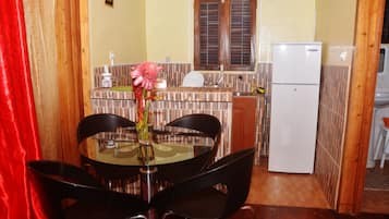 A compact kitchen with a dining area.