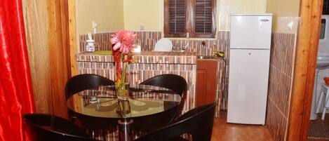 A compact kitchen with a dining area.