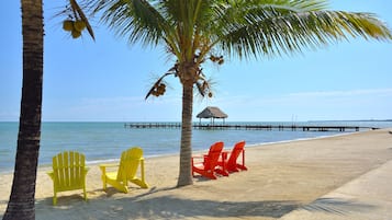 On the beach, white sand, sun-loungers, beach umbrellas
