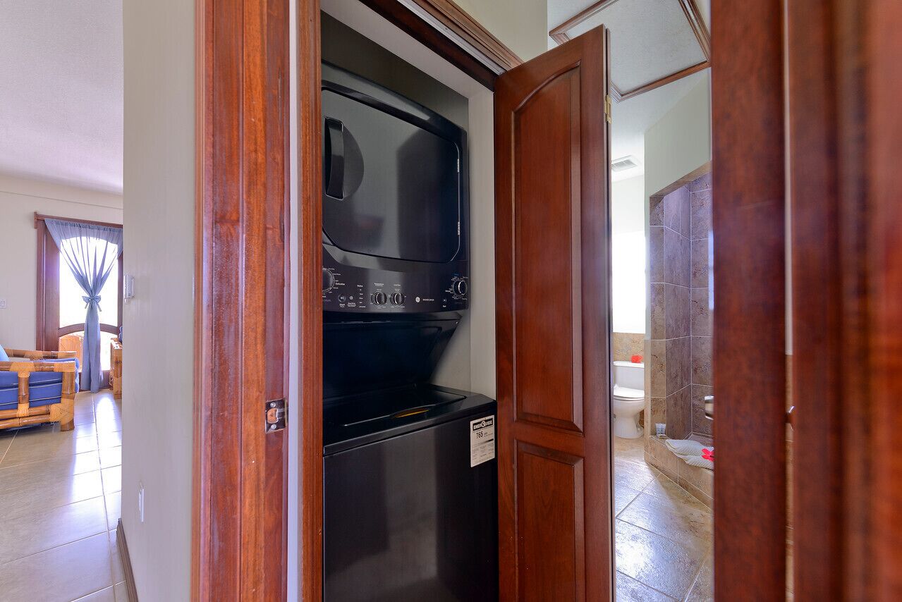 A compact kitchen with a built-in oven and a refrigerator.