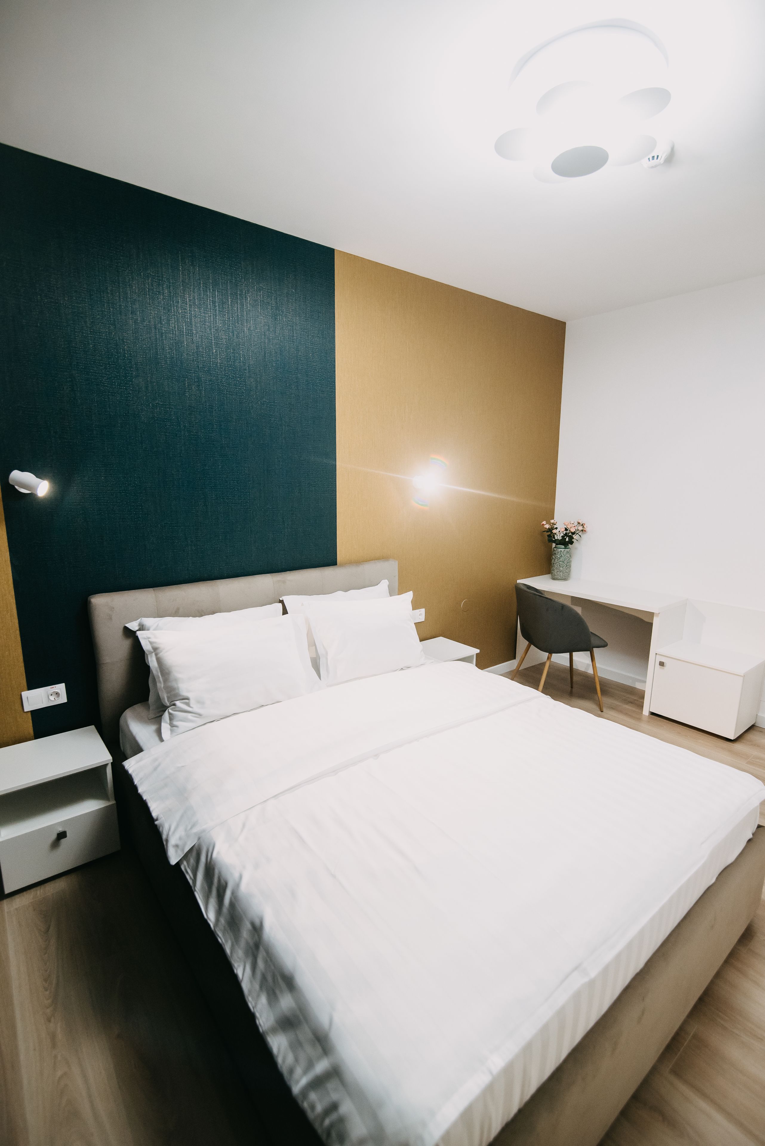Una camera da letto moderna con un letto grande, una scrivania e una sedia.