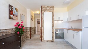 A modern kitchen with white cabinets, a wooden countertop, and a built-in oven. - Apartment in Castle Harbor, heated pool, satellite TV channels (Los Cristianos)