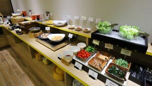 A buffet with various food items and condiments.