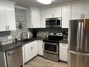 Microwave, dishwasher, coffee/tea maker, cookware/dishes/utensils