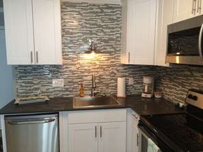 Microwave, dishwasher, coffee/tea maker, cookware/dishes/utensils