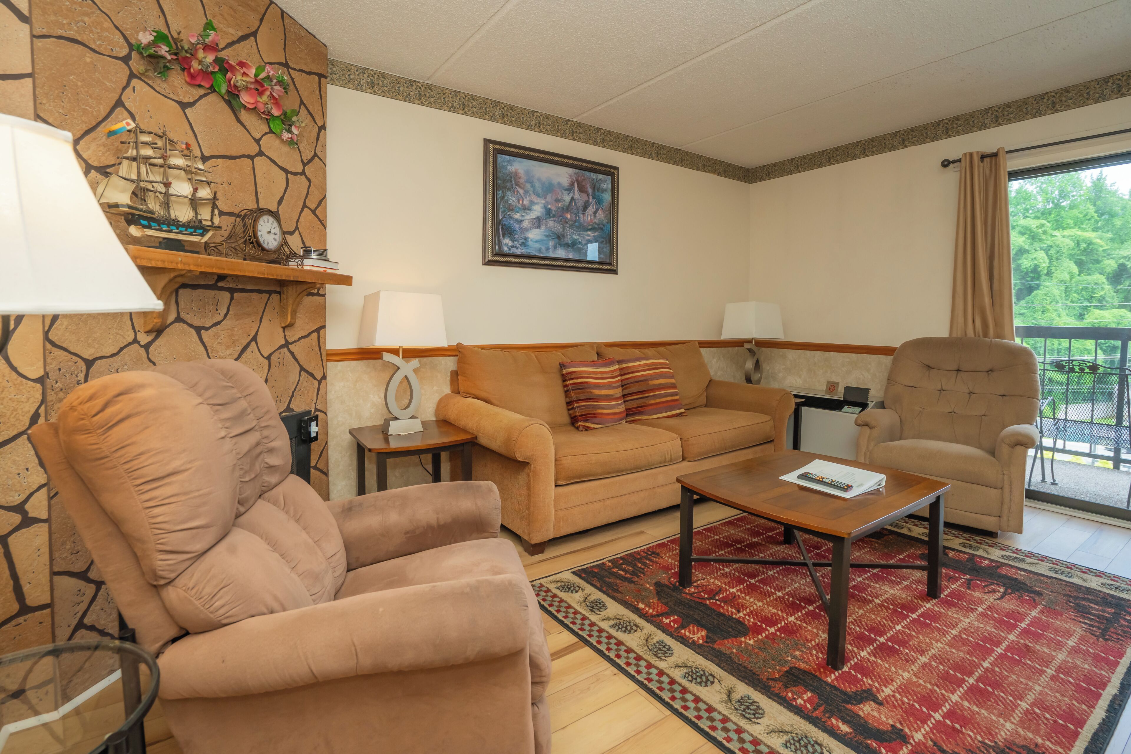 A living room with a sofa, armchair, coffee table, and a decorative clock.