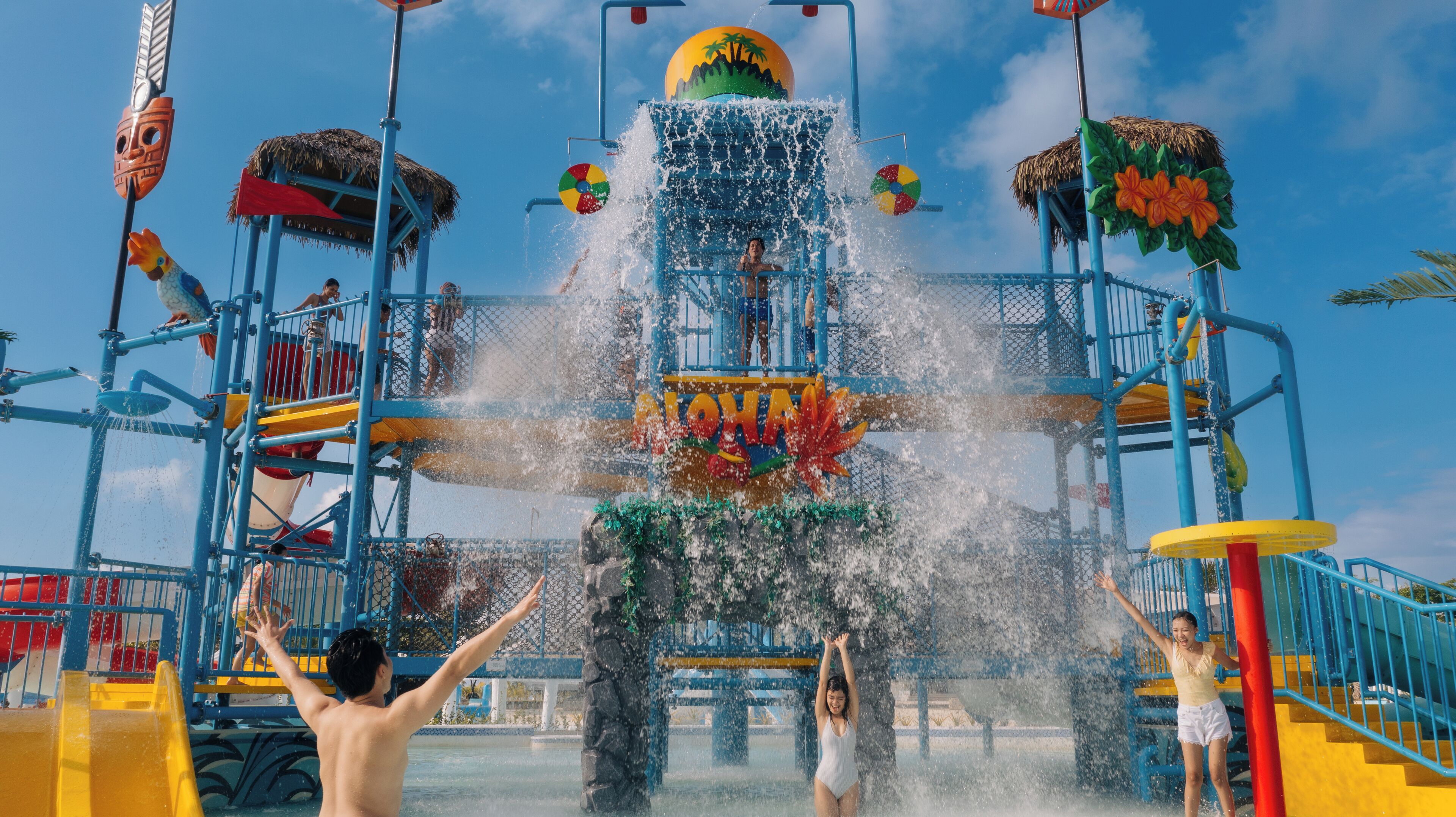 A water park with a large water slide and multiple play structures.