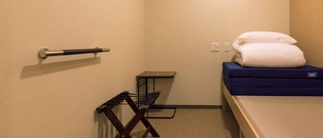 A small, compact room with a bunk bed, a small table, and a chair.