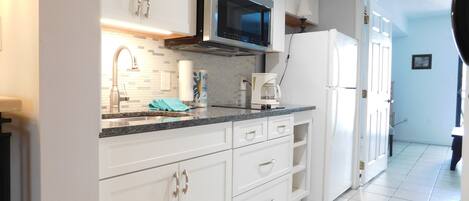 Full-size fridge, microwave, stovetop, coffee/tea maker