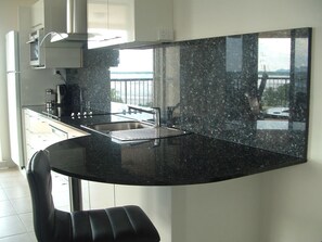 Panoramic Apartment | Private kitchen | Full-size fridge, microwave, oven, stovetop - Cairns Apartment Esplanade Ocean Views (Cairns)