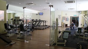 A gym with treadmills, weight machines, and a bench. - 1 Ivy Suite At Berjaya Times Square (Kuala Lumpur)
