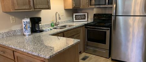 Fridge, microwave, stovetop, coffee/tea maker