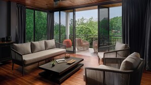 A modern living room with a sofa, chairs, and a coffee table. - The Namkhan, a Small Luxury Hotel of the World (Luang Prabang)