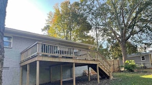 A wooden deck with a staircase leading to a house. - RElax, & BeComfortable (Snellville)