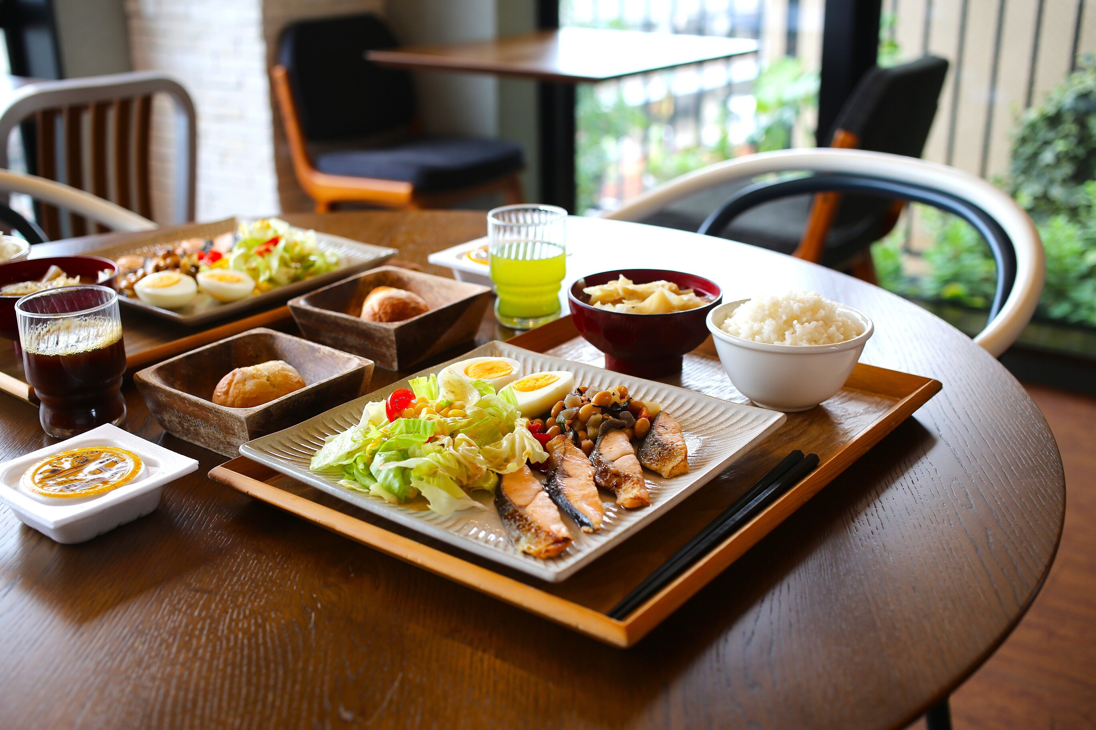 A dining table with various dishes including sushi, rice, and vegetables.