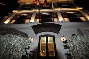 A building with a grand entrance, large windows, and a flag. - West Loch Park Hotel Vigan (Vigan)