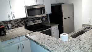 Microwave, dishwasher, coffee/tea maker, cookware/dishes/utensils