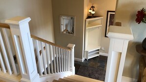 A staircase with white railings and wooden steps leading to a landing. - Fall hiking & mtn biking from front door! Large Chef's kitchen, serene backyard  (Bend)