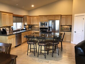 Enjoy cooking in this well-lit kitchen with a central island and stainless steel appliances.