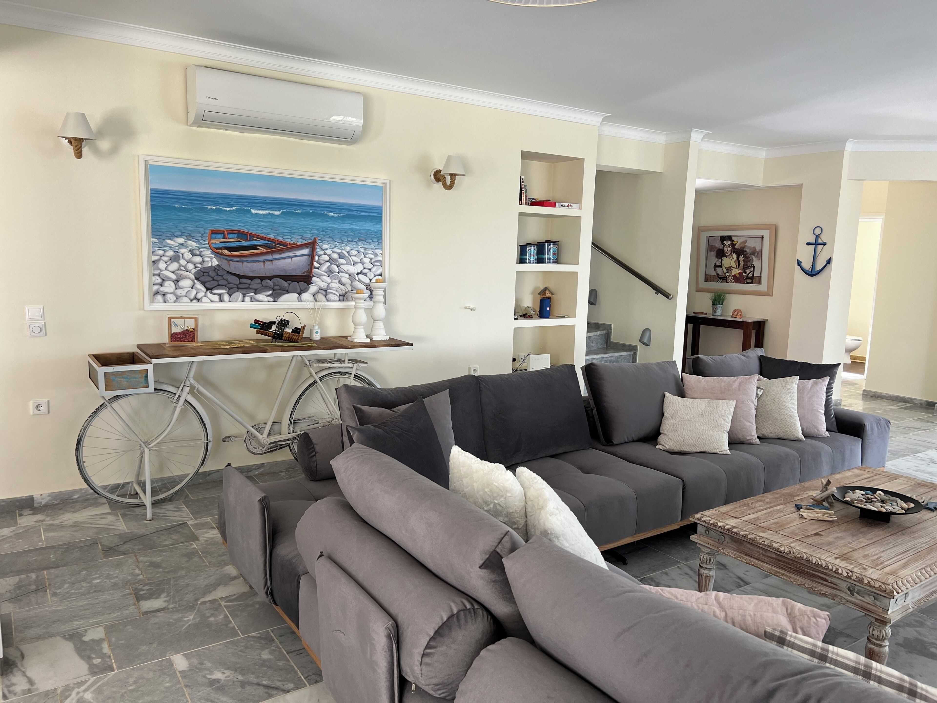 A living room with a gray sofa, a coffee table, and a bicycle.
