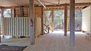 A wooden structure with exposed beams and a wooden deck. - Wild Peony:  Incredible views from the ever popular rooftop deck! (Ocracoke)