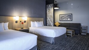 A hotel room with two beds, a sofa, a small table, and a wall-mounted picture. - Hyatt Place Indianapolis / Fishers (Fishers)