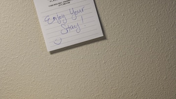 A note pinned to a wall with a Hyatt Place logo, a handwritten message, and a pen on a wooden surface.