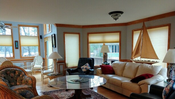A living room with a sofa, chairs, a coffee table, and a sailboat decoration. - Large, safe, WATERFRONT home in Idyllic setting with kayaks, bikes, &GARAGE use. (Reedville)