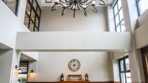 A spacious lobby with a high ceiling, a large chandelier, a fireplace, and seating arrangements. - Royale Parc Hotel Tagaytay (Tagaytay)