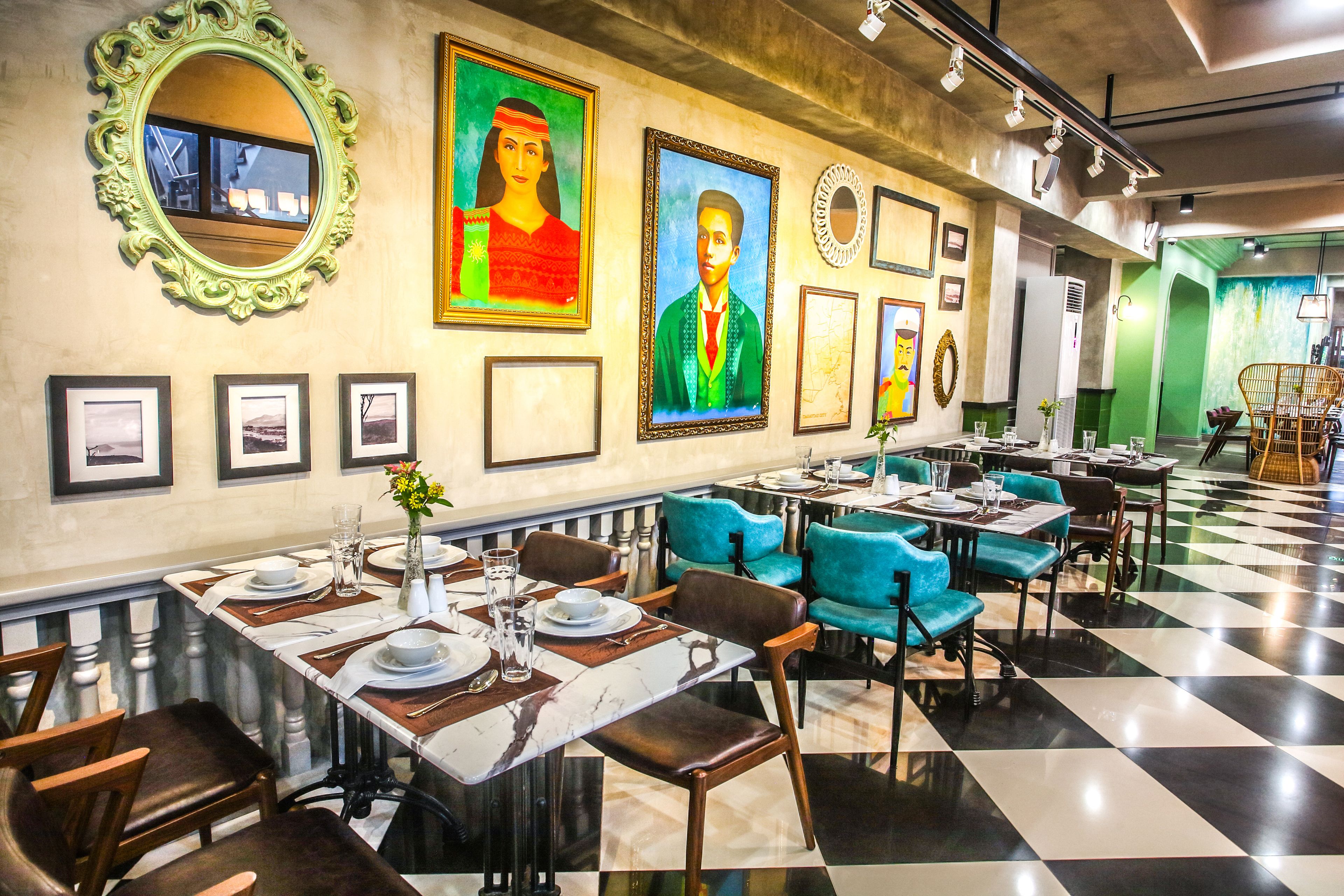 A restaurant with checkered flooring, teal and brown chairs, and framed artwork on the walls.