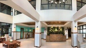 A spacious lobby with a reception desk, seating areas, and a fireplace. - Royale Parc Hotel Tagaytay (Tagaytay)