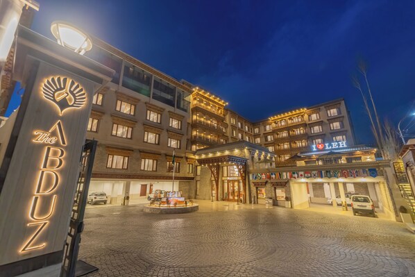 A hotel with a prominent sign reading "The ABDUZ" and a large entrance with a decorative archway.