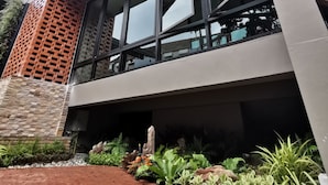 A modern building with large windows, a brick facade, and a rooftop garden. - Fang Chiang Mai (Chiang Mai)