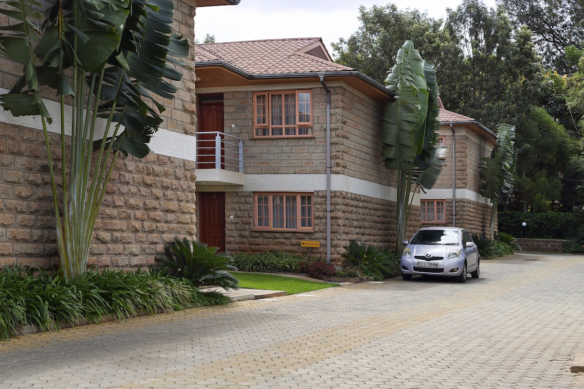 A stone building with a car parked in front.