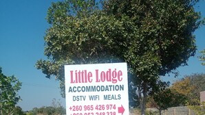 A sign for Little Lodge Accommodation offering DSTV, WiFi, and meals. - Little Lodge (Choma)