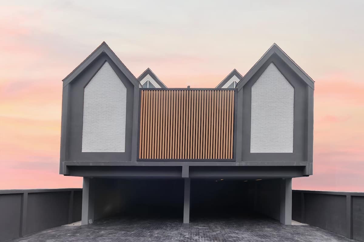 A modern building with a flat roof and a wooden slatted wall.