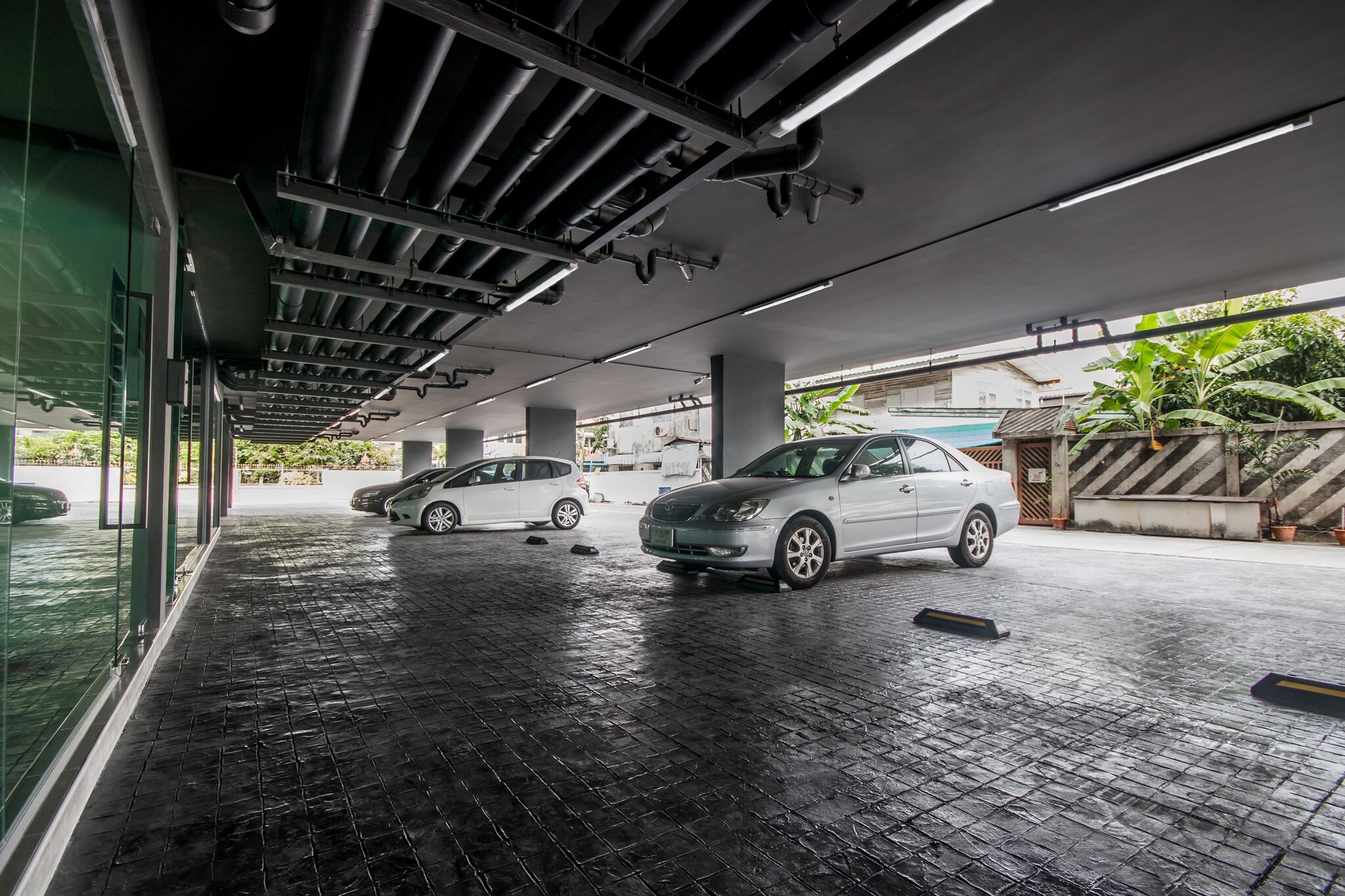 Un aparcamiento interior moderno con el suelo mojado, señal de limpieza reciente o lluvia.