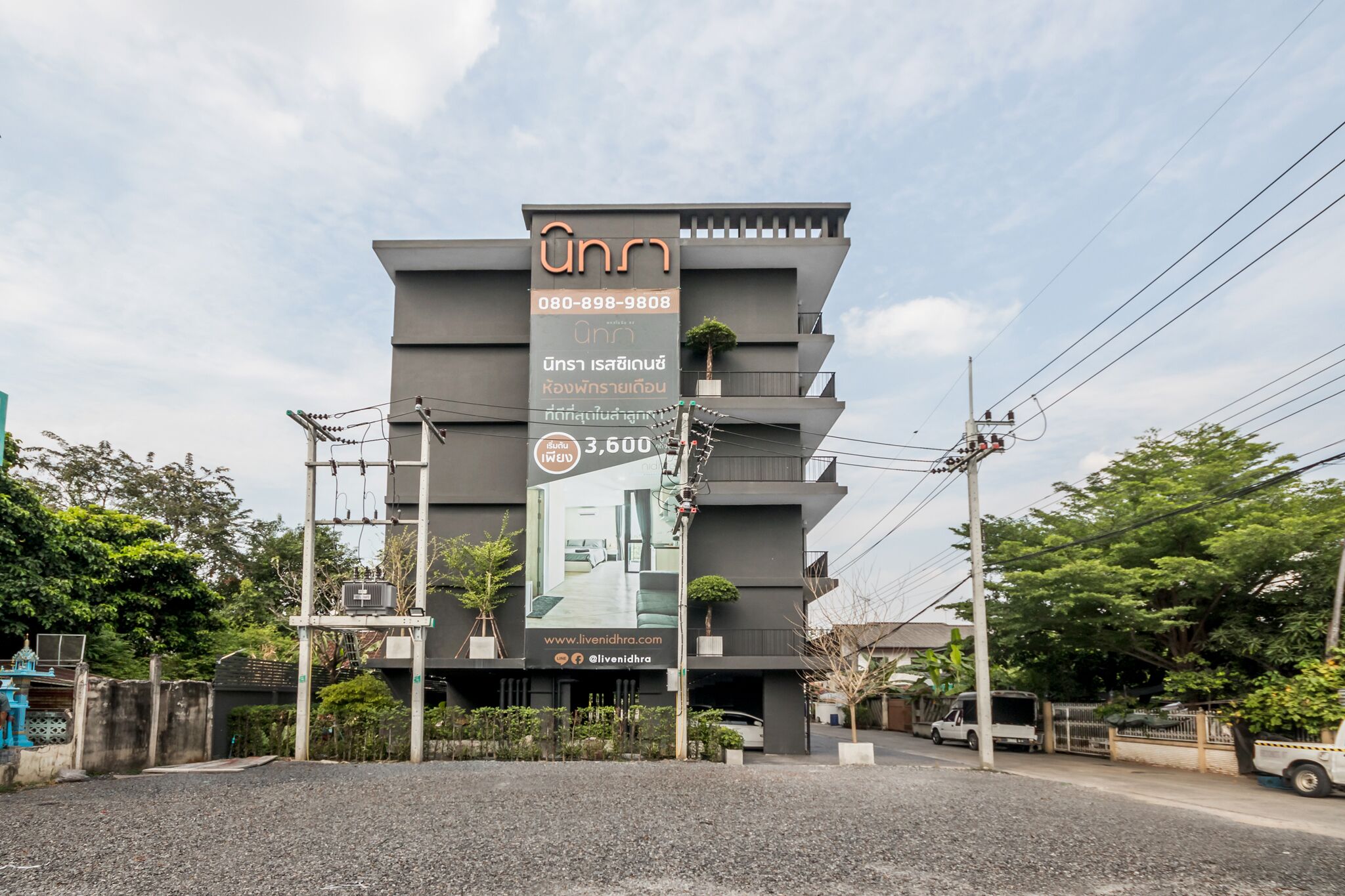 A modern building with a prominent sign advertising a 3,600 square meter property.