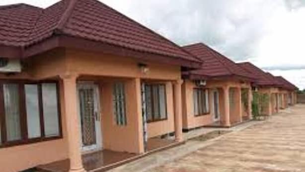 A row of single-story houses with a uniform architectural style, featuring a flat roof and a simple, functional design.