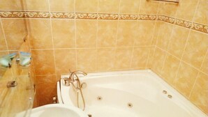 A bathroom with a bathtub, a sink, and a shower. - Welcome Home 7 (Tashkent)