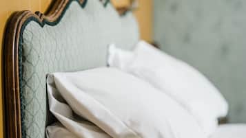 A bed with a headboard and pillows.